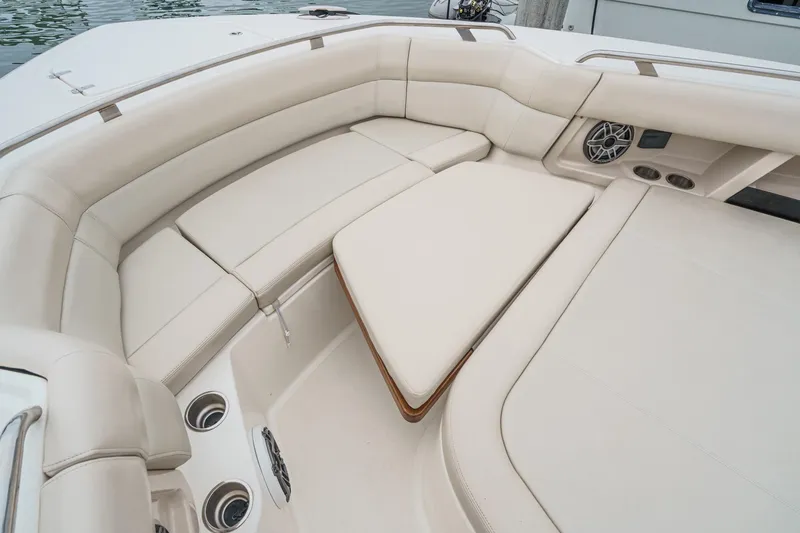 Slide: The Image of Luxurious seating area on 2022 Boston Whaler 350 Realm boat, featuring plush cushions and built-in speakers. - 68