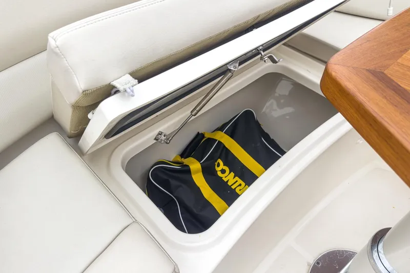 Slide: The Image of Storage compartment on 2022 Boston Whaler 350 Realm with a duffel bag inside. - 76