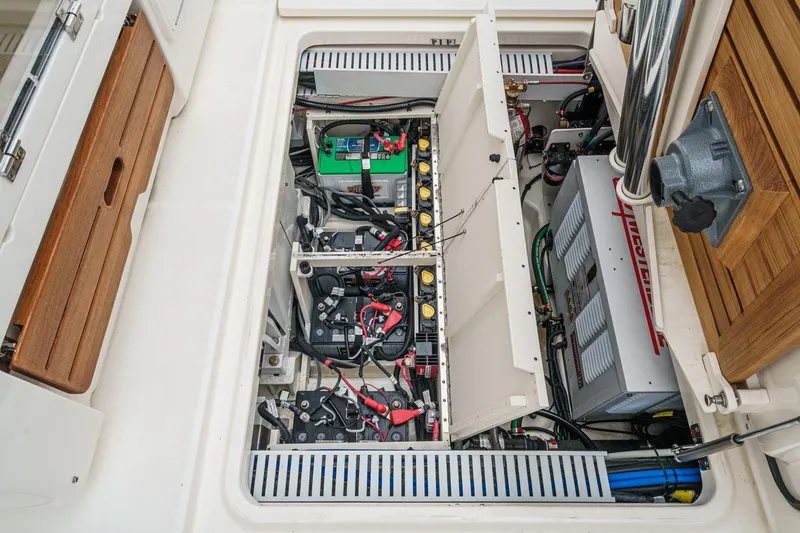 Slide: The Image of 2022 Boston Whaler 350 Realm engine compartment showcasing batteries and electrical systems. - 87