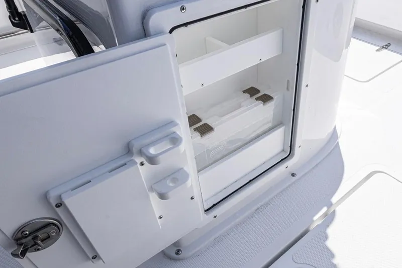 Slide: The Image of Open storage compartment on 2026 Sea Hunt Gamefish 25 boat, featuring organized interior space. - 18