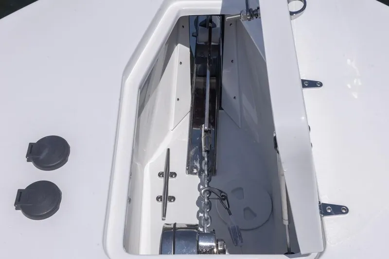 Slide: The Image of Anchor compartment of 2026 Sea Hunt Gamefish 25 boat, featuring chain and hardware. - 2