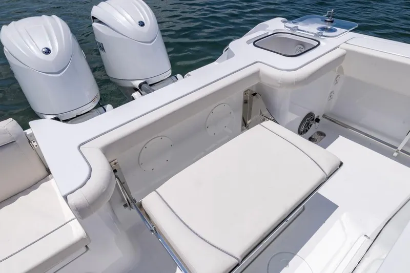 Slide: The Image of 2026 Sea Hunt Gamefish 25 boat with dual engines and seating area on water. - 22