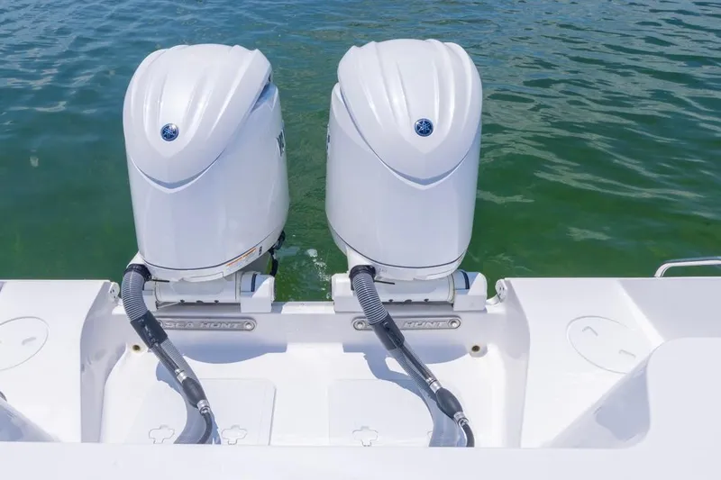 Slide: The Image of 2026 Sea Hunt Gamefish 25 with dual outboard motors on water. - 25
