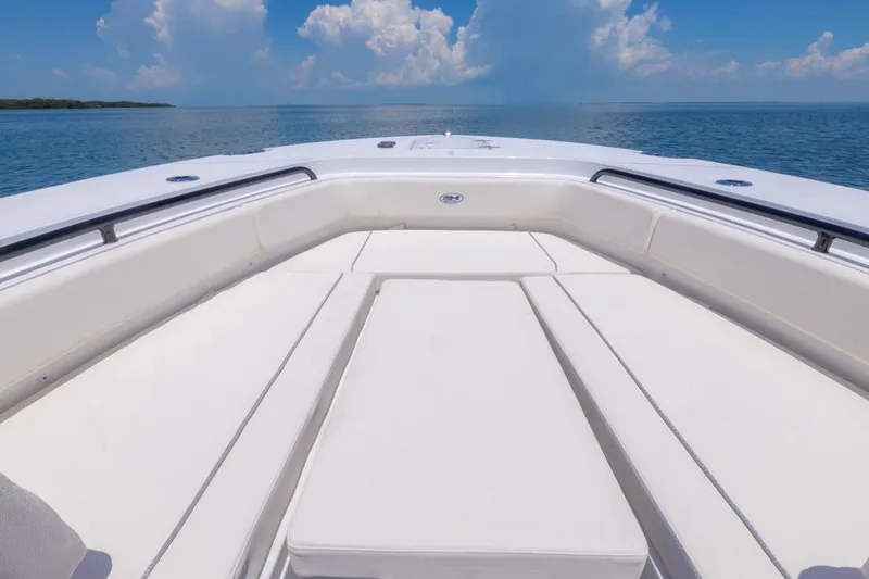 Slide: The Image of 2026 Sea Hunt Gamefish 25 boat interior with cushioned seating, ocean view, and blue sky. - 4