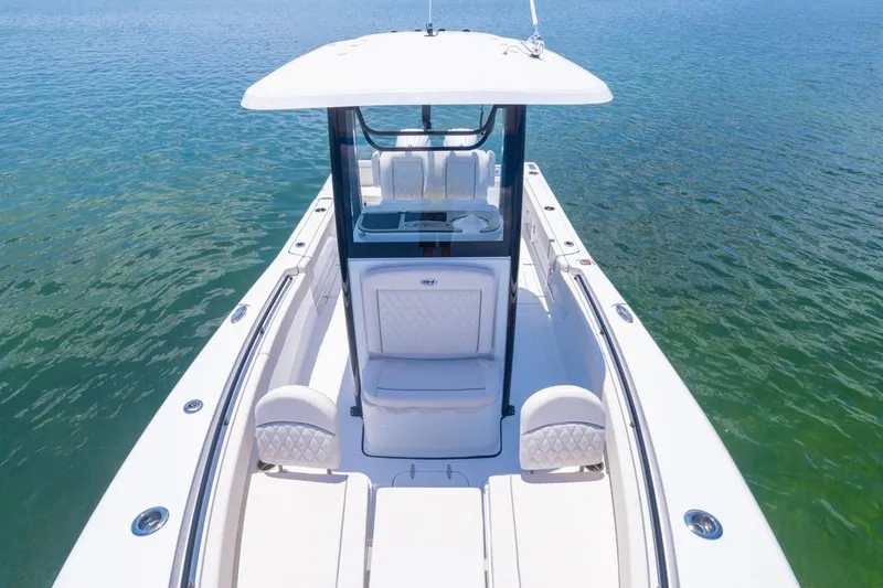 Slide: The Image of 2026 Sea Hunt Gamefish 25 boat on clear water, showcasing sleek design and spacious seating. - 5