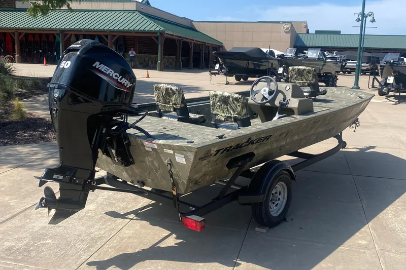 Slide: The Image of 2024 Tracker Grizzly 1754SC boat with Mercury engine on trailer, outdoor display. - 3