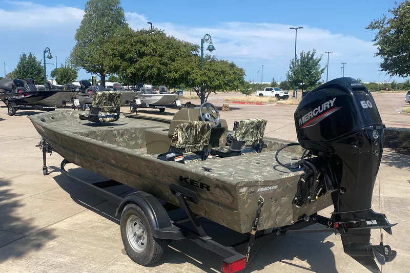 Slide: The Image of 2024 Tracker Grizzly 1754SC boat with Mercury 60 engine, parked outdoors. - 4