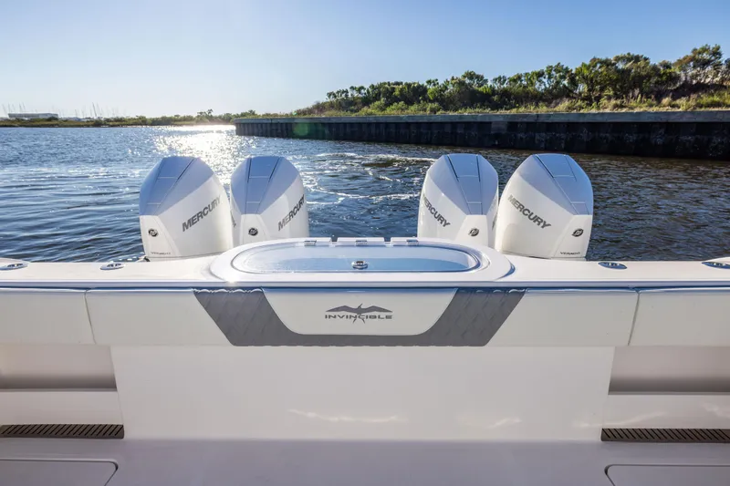 Slide: The Image of 2025 Invincible 38 Catamaran with four Mercury engines on a sunny day. - 13
