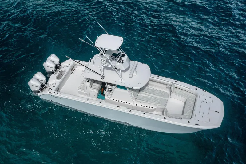 Slide: The Image of 2025 Invincible 38 Catamaran cruising on clear blue ocean waters. - 18