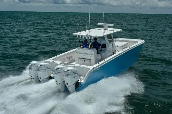 Slide: The Image of 2025 Invincible 38 Catamaran cruising on open water with triple outboard engines. - 29