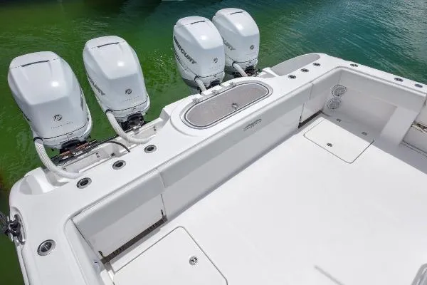 Slide: The Image of 2025 Invincible 38 Catamaran with four powerful outboard engines on turquoise water. - 24