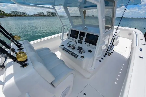 Slide: The Image of 2025 Invincible 38 Catamaran cockpit with modern controls, overlooking serene waters and city skyline. - 25