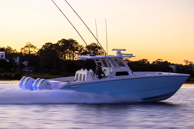Slide: The Image of 2025 Invincible 38 Catamaran cruising at sunset on calm waters. - 1