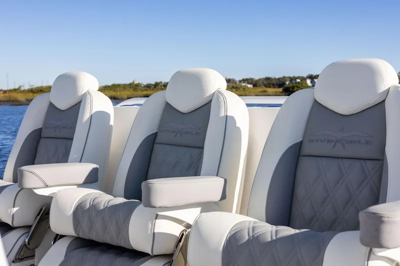 Slide: The Image of Luxury seating on 2025 Invincible 38 Catamaran, featuring elegant gray and white upholstery. - 17