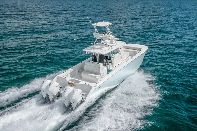 Slide: The Image of 2025 Invincible 38 Catamaran cruising on open ocean waters. - 19