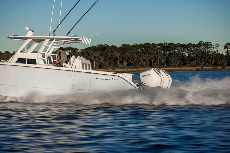 Slide: The Image of 2025 Invincible 38 Catamaran cruising on water, showcasing powerful engines and sleek design. - 9