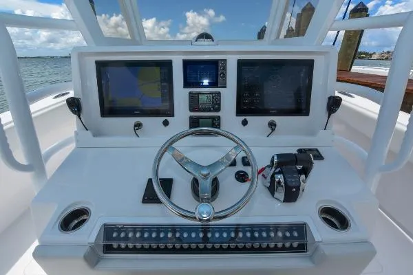 Slide: The Image of Helm of 2025 Invincible 38 Catamaran with advanced navigation displays and controls. - 23