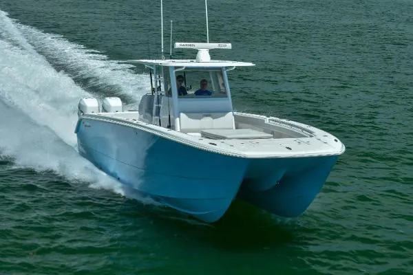 Slide: The Image of 2025 Invincible 38 Catamaran cruising on open water, showcasing sleek design and performance. - 20