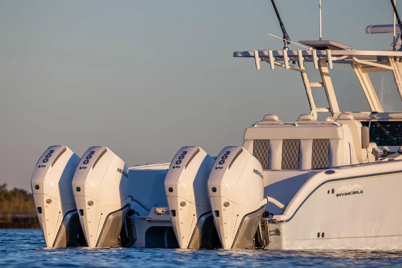 Slide: The Image of 2025 Invincible 38 Catamaran with quad outboard engines on calm water. - 5