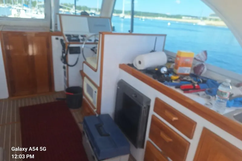 Slide: The Image of Interior of a 2007 Northern Bay Hardtop Cruiser with tools and supplies on the counter. - 10