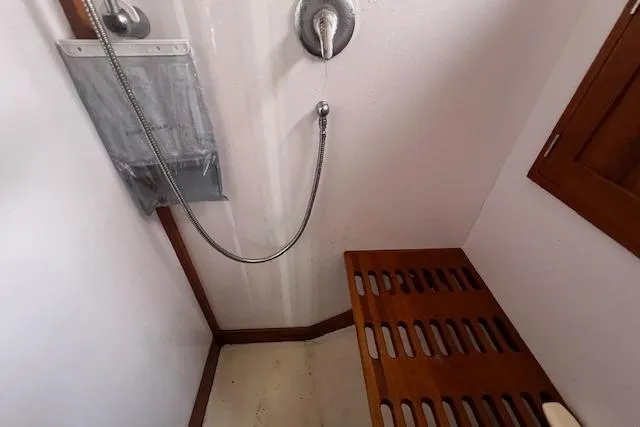 Slide: The Image of Shower area in 2007 Northern Bay Hardtop Cruiser with wooden bench and handheld showerhead. - 15