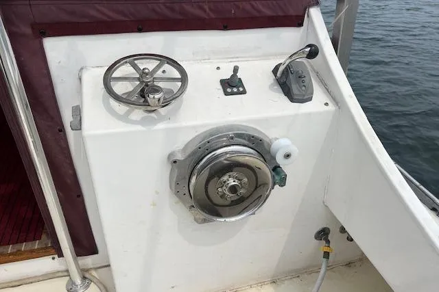 Slide: The Image of Control panel of a 2007 Northern Bay Hardtop Cruiser/Fishing Vessel, featuring steering and throttle. - 17