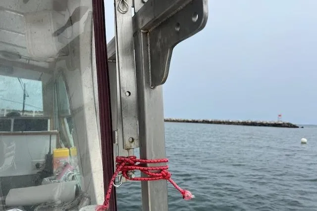 Slide: The Image of 2007 Northern Bay Hardtop Cruiser on calm waters near a rocky shoreline. - 18