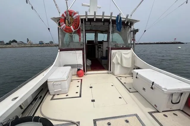 Slide: The Image of 2007 Northern Bay Hardtop Cruiser/Fishing Vessel on calm water, equipped with fishing gear. - 19