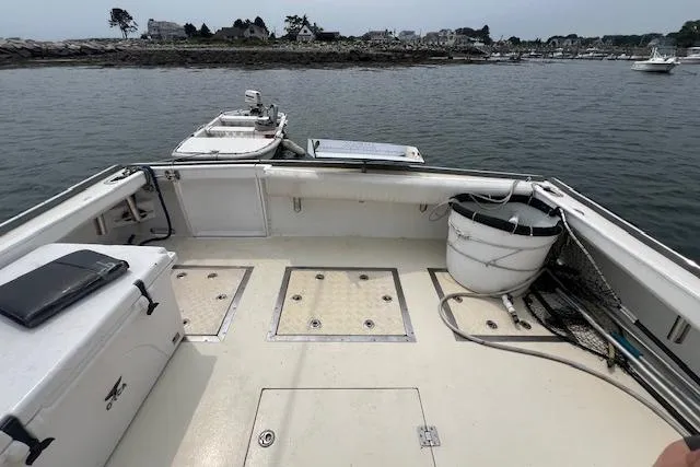 Slide: The Image of 2007 Northern Bay Hardtop Cruiser/Fishing Vessel with spacious deck, docked near rocky shoreline. - 20