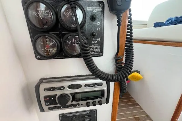 Slide: The Image of Control panel of a 2007 Northern Bay Hardtop Cruiser/Fishing Vessel with gauges and radio. - 26