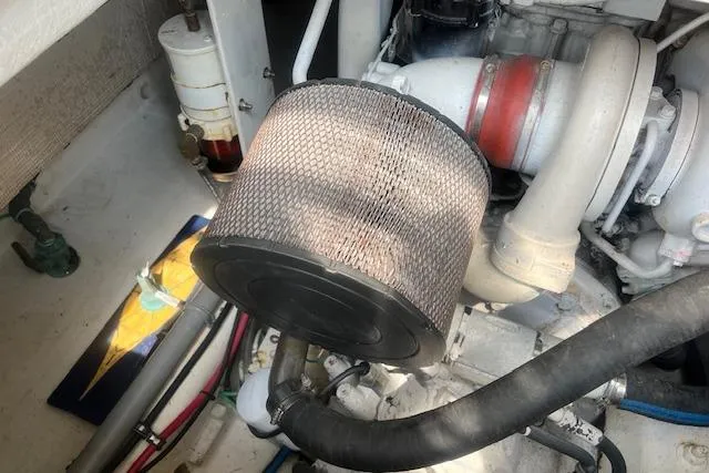 Slide: The Image of Engine compartment of a 2007 Northern Bay Hardtop Cruiser/Fishing Vessel, featuring air filter and hoses. - 29