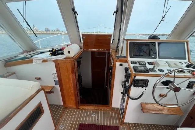 Slide: The Image of 2007 Northern Bay Hardtop Cruiser interior with navigation equipment and wooden finishes. - 5