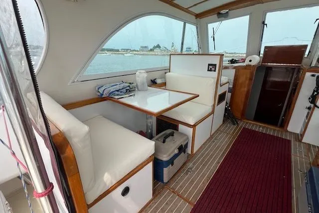 Slide: The Image of 2007 Northern Bay Hardtop Cruiser interior with seating, table, and ocean view. - 7