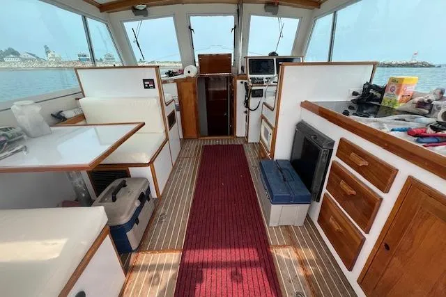 Slide: The Image of 2007 Northern Bay Hardtop Cruiser interior with wood accents and navigational equipment. - 9