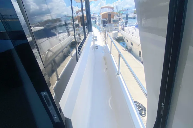 Slide: The Image of Side deck view of a 1990 Viking 63 Motor Yacht in a marina. - 10