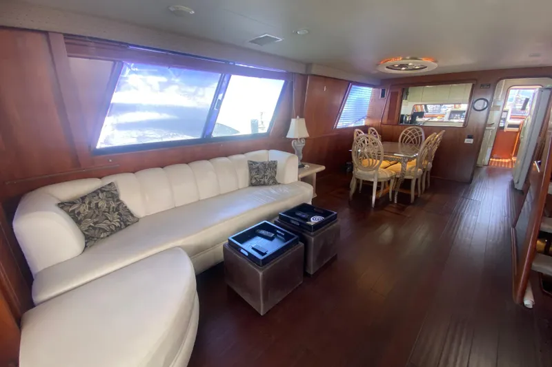 Slide: The Image of Luxurious interior of 1990 Viking 63 Motor Yacht with elegant seating and dining area. - 12