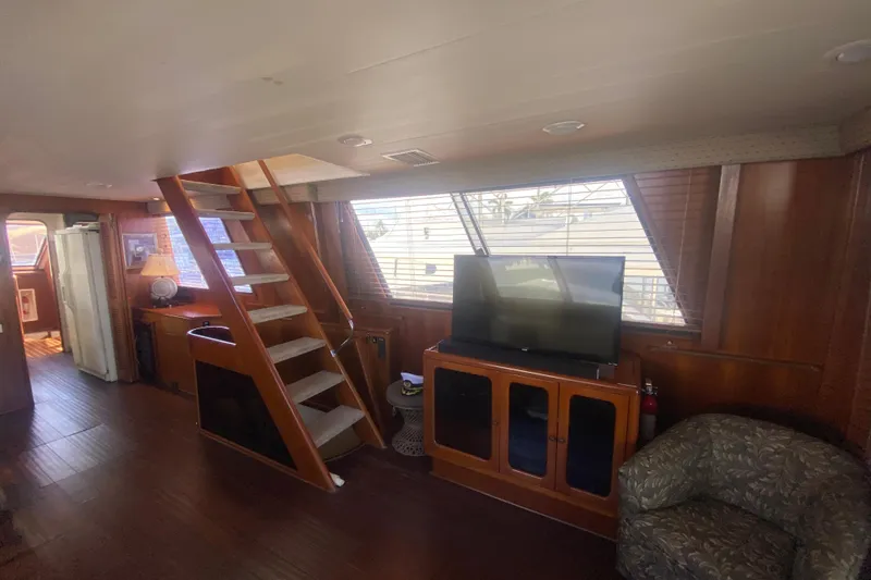 Slide: The Image of Interior of 1990 Viking 63 Motor Yacht with wooden decor and modern amenities. - 14