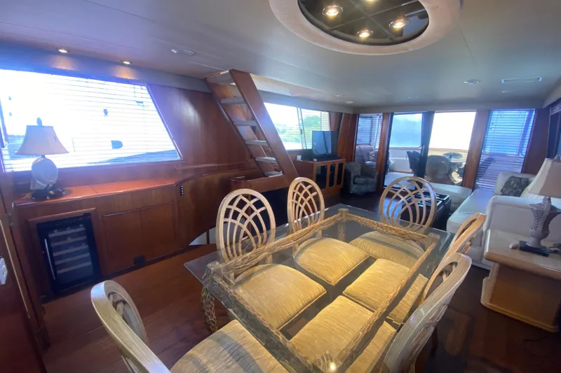 Slide: The Image of Luxurious interior of 1990 Viking 63 Motor Yacht with elegant dining area and cozy seating. - 17