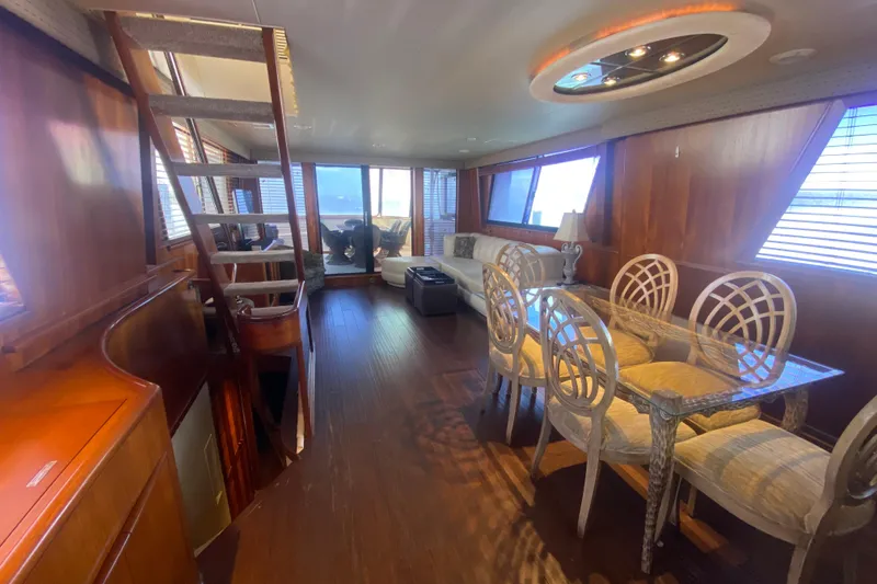 Slide: The Image of Luxurious interior of 1990 Viking 63 Motor Yacht with elegant dining area and seating. - 18