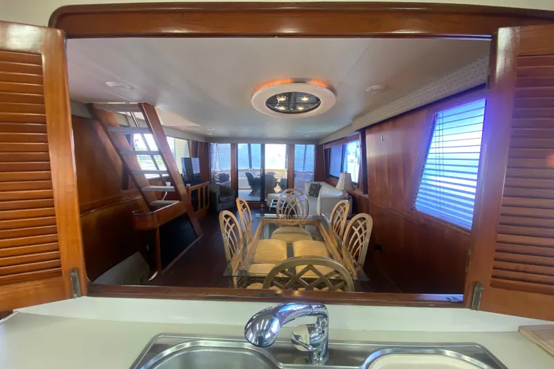 Slide: The Image of Interior of 1990 Viking 63 Motor Yacht with dining area and wooden accents. - 19
