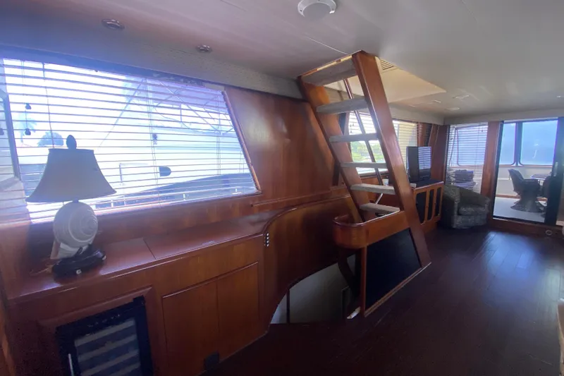 Slide: The Image of Interior of 1990 Viking 63 Motor Yacht with wooden finishes and modern furnishings. - 21