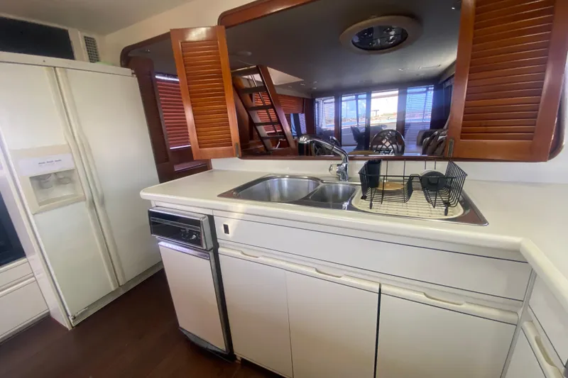 Slide: The Image of Interior kitchen of a 1990 Viking 63 Motor Yacht with sink and appliances. - 22