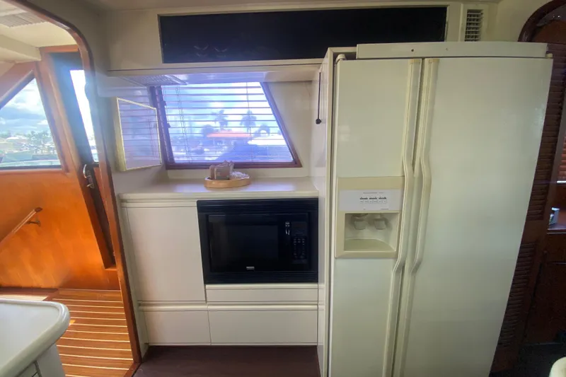 Slide: The Image of Interior of 1990 Viking 63 Motor Yacht kitchen with fridge and microwave. - 26