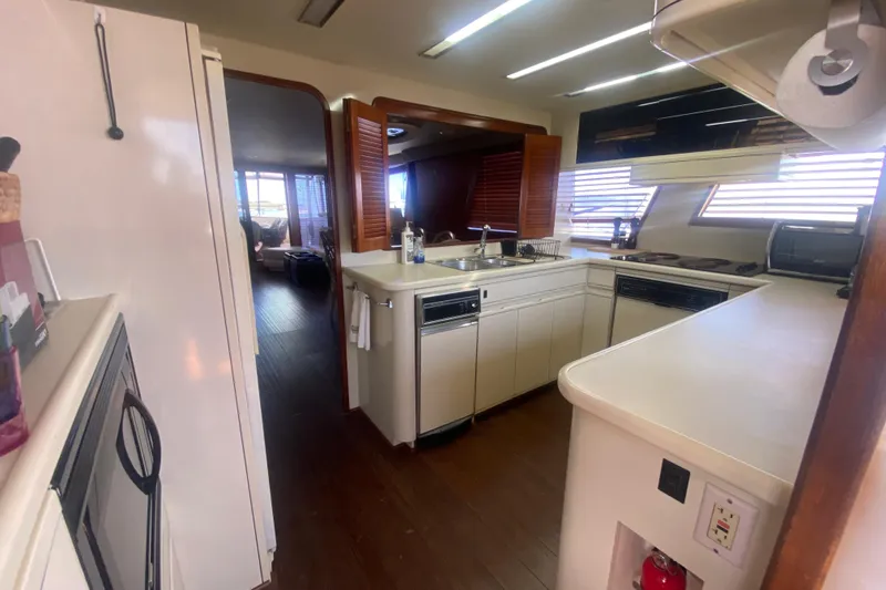 Slide: The Image of Interior kitchen of a 1990 Viking 63 Motor Yacht with modern appliances. - 27
