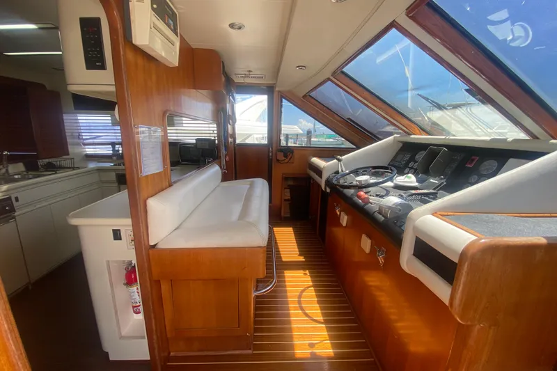 Slide: The Image of Interior of 1990 Viking 63 Motor Yacht with helm and seating area. - 28