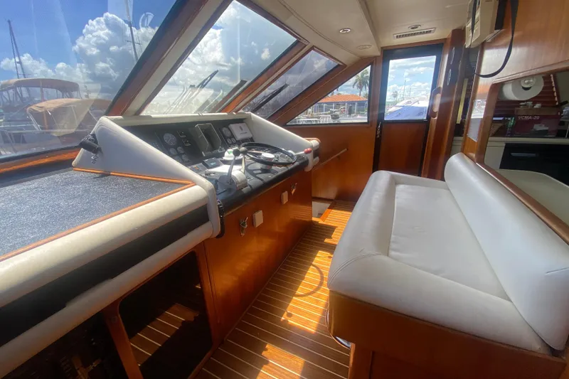 Slide: The Image of Interior of 1990 Viking 63 Motor Yacht with helm and seating area. - 31