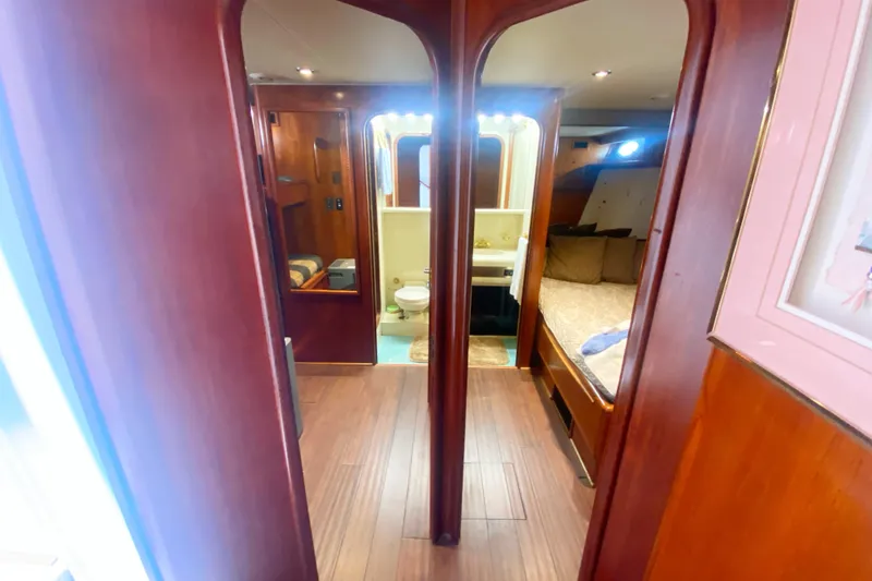 Slide: The Image of Interior of 1990 Viking 63 Motor Yacht with wood paneling, bedroom, and bathroom. - 34