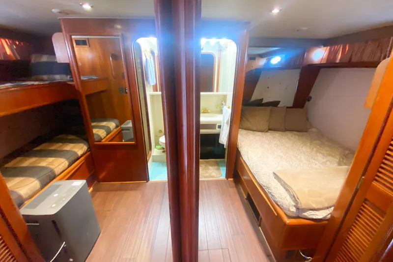 Slide: The Image of Luxurious interior of 1990 Viking 63 Motor Yacht with cozy sleeping quarters. - 35