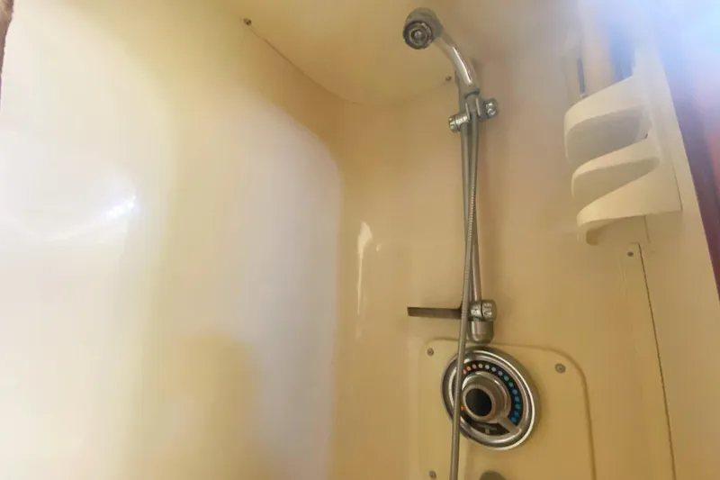 Slide: The Image of Shower area in 1990 Viking 63 Motor Yacht, featuring adjustable showerhead and control panel. - 40