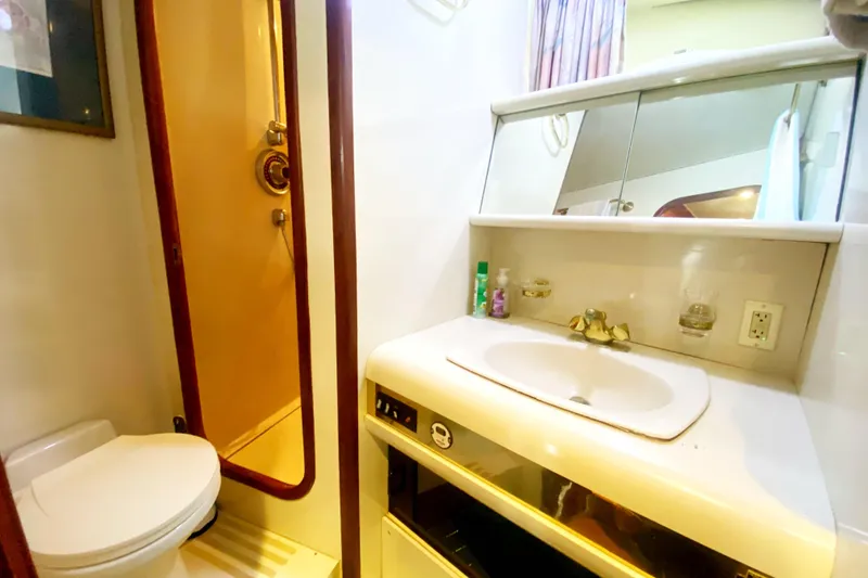 Slide: The Image of Bathroom interior of 1990 Viking 63 Motor Yacht with sink, mirror, and shower. - 43